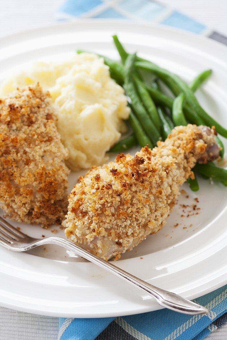 Buttermilk Baked Chicken with Mashed Potatoes and Green Beans on a White Plate