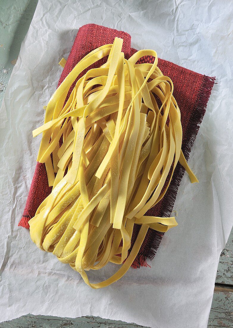 Tagliatelle on a red cloth