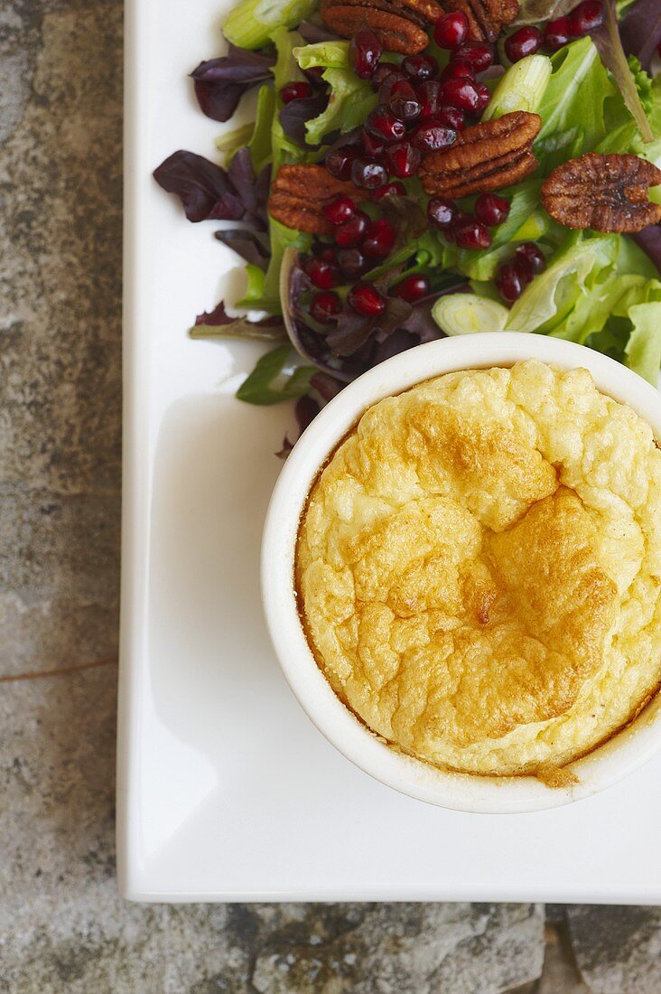 Individual Cheese Souffle with a Mixed Green Salad with Pecans and Pomegranate Seeds; From Above