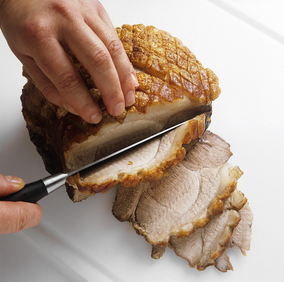 Carving roast pork with crackling