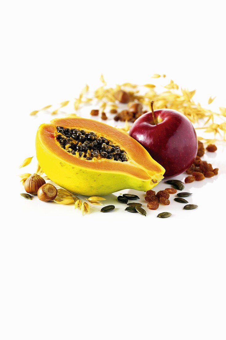 Ingredients for müsli: papaya, apple, nuts, pumpkin seeds and raisins
