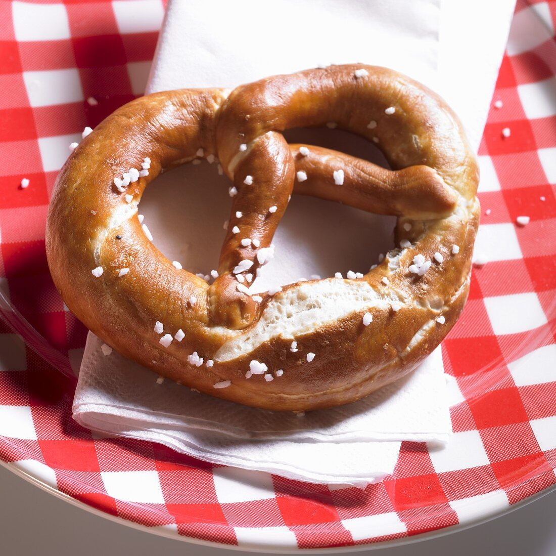 Lye pretzel on a plaid plate
