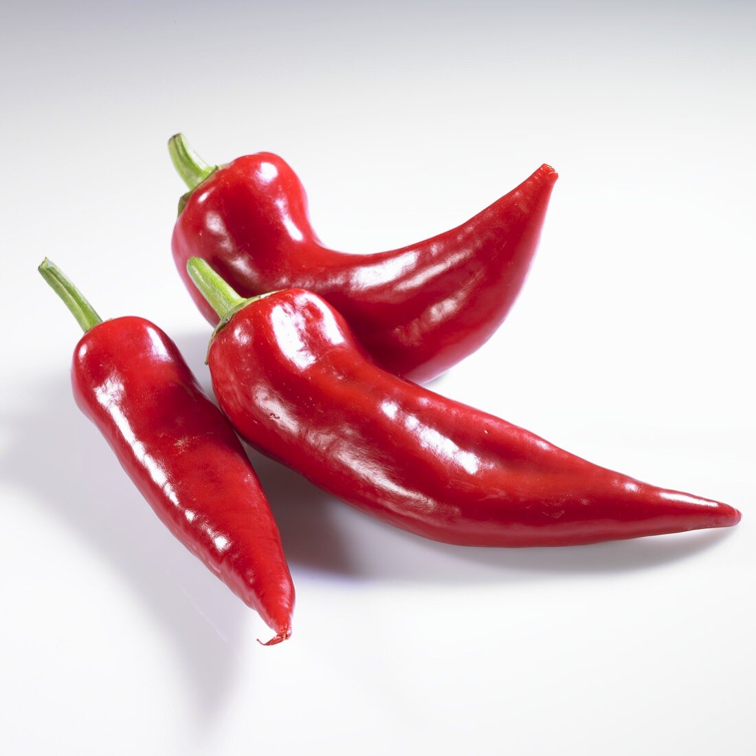Three red pointed peppers
