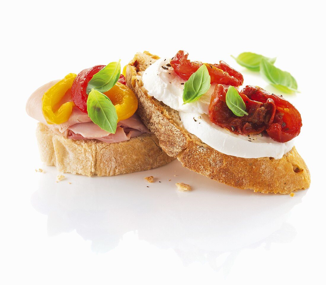 Slices of ciabatta bread with ham, pepper, mozzarella and tomatoes