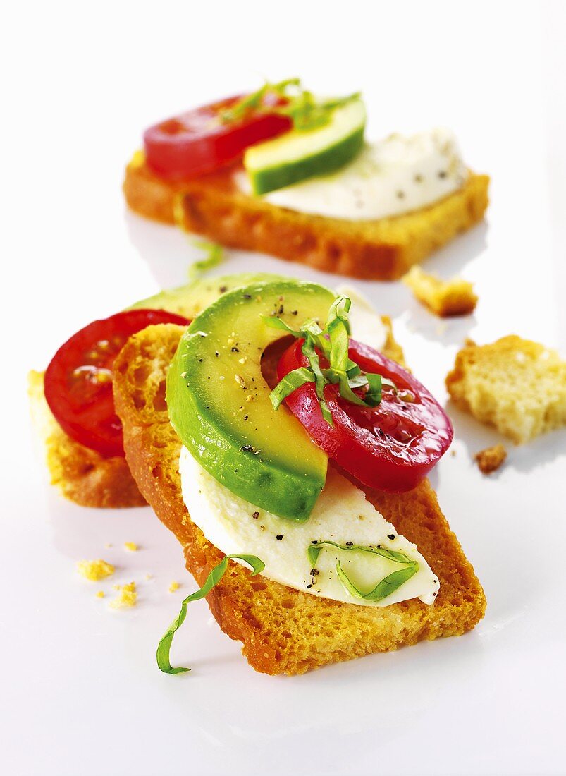 Bruschetta with avocado, tomatoes and mozzarellla