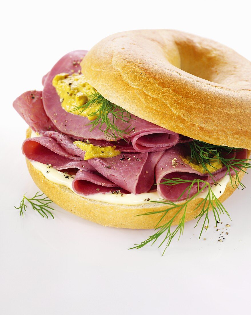 Bagel with cream cheese, cured beef, mustard and dill
