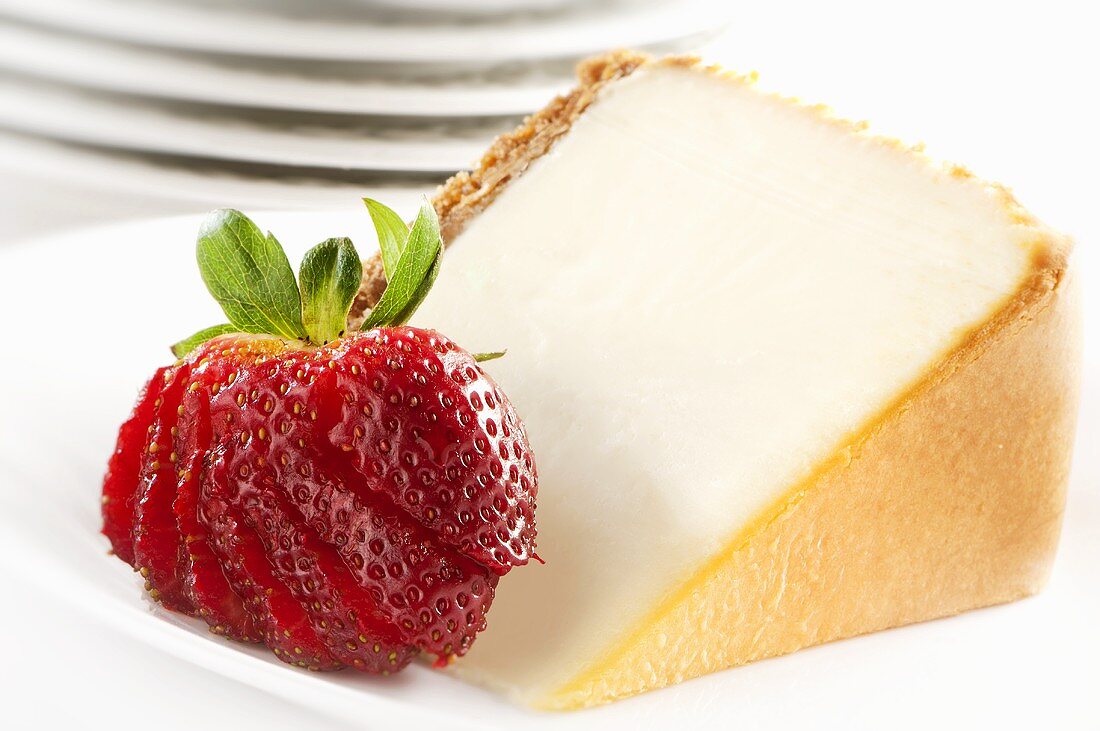 Slice of Cheesecake with Cracker Crust and Sliced Strawberry