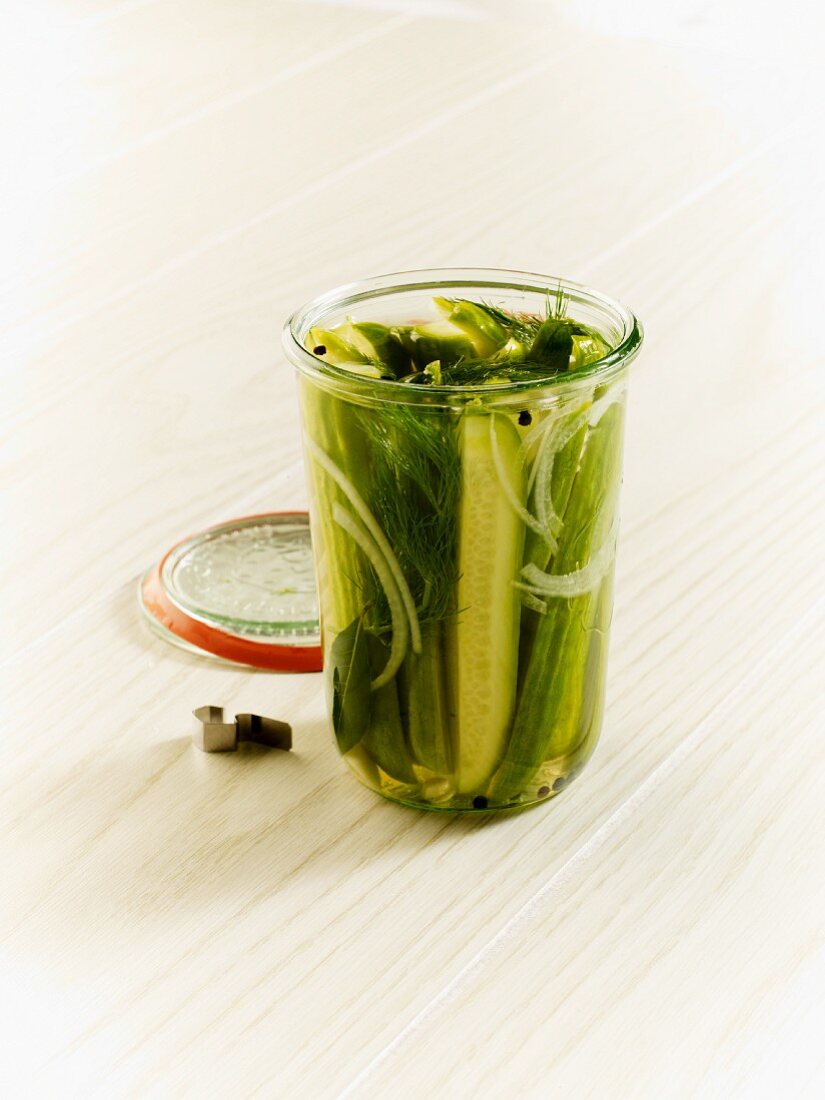 Homemade dill gherkins in an open jar