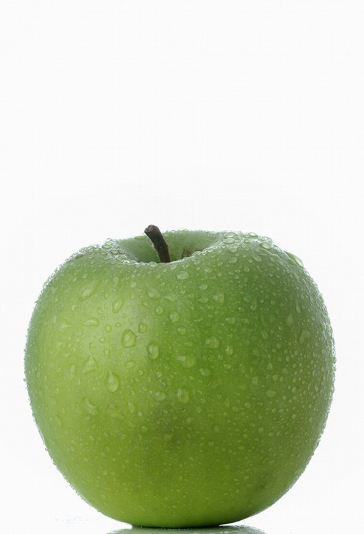 Green apple with drops of water