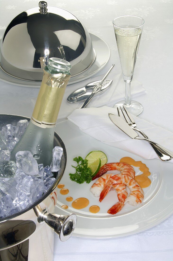 Place-setting with prawns and sparkling wine