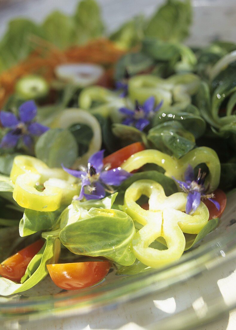 Corn salad with peppers, tomatoes and borage flowers