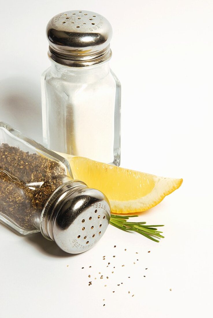 Salt and (upset) pepper shakers with lemon wedge
