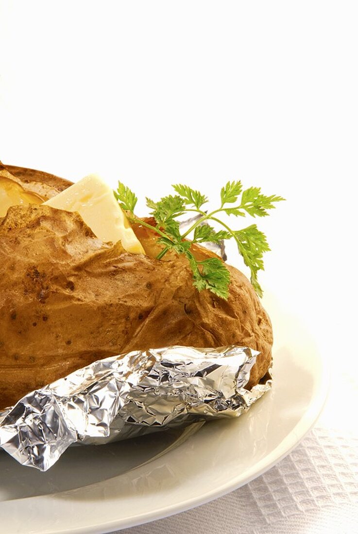 A baked potato with butter and chervil