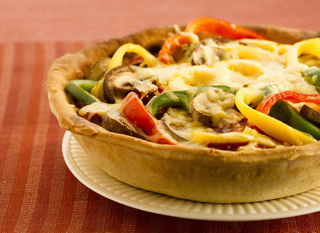 Pepper and mushroom tart with melted cheese topping