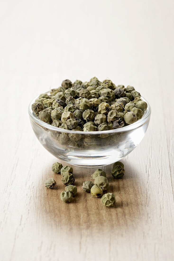 Green peppercorns in a small glass dish