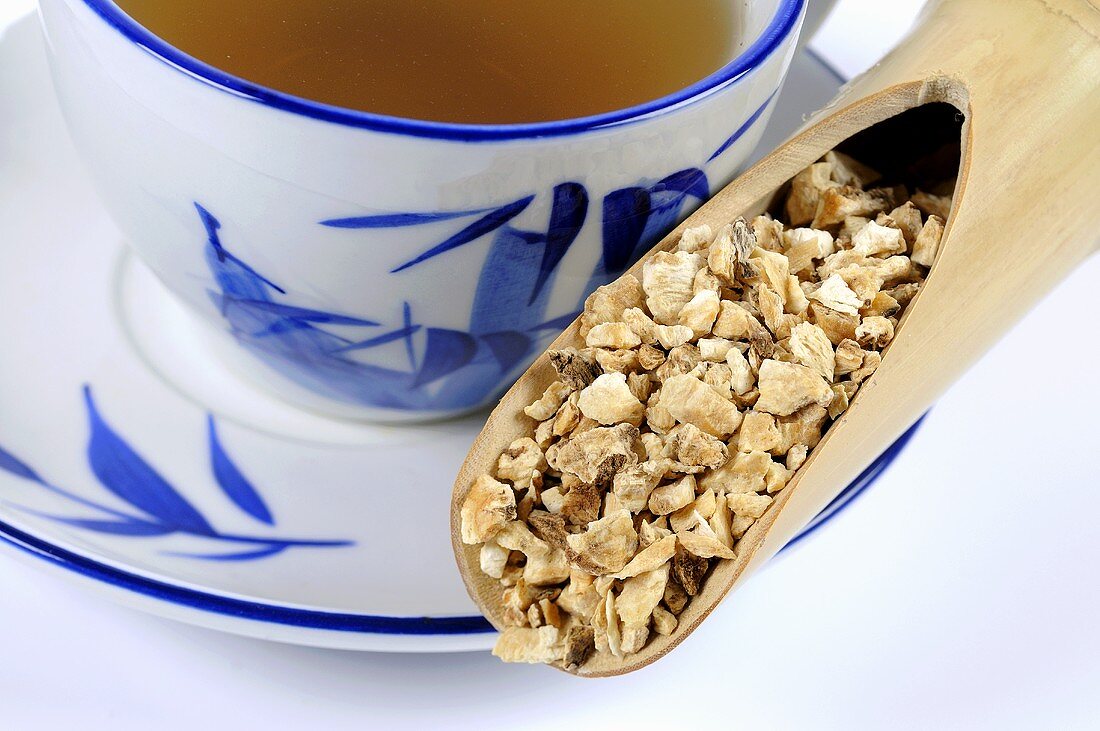 Chinese angelica root with a cup of tea