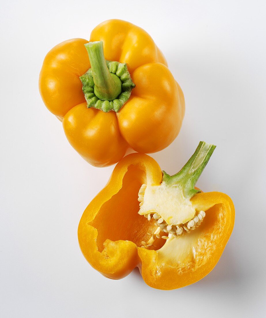 Whole yellow pepper and half a yellow pepper