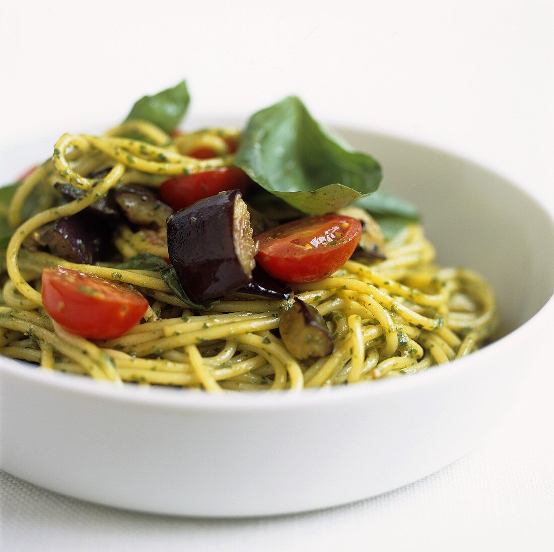 Spaghetti with tomatoes, aubergine and basil pesto