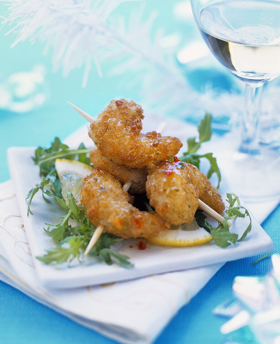 Deep-fried prawns on cocktail sticks with rocket