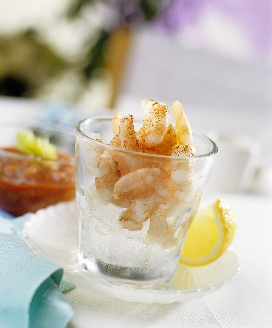 Prawns on crushed ice in glass, chilli sauce