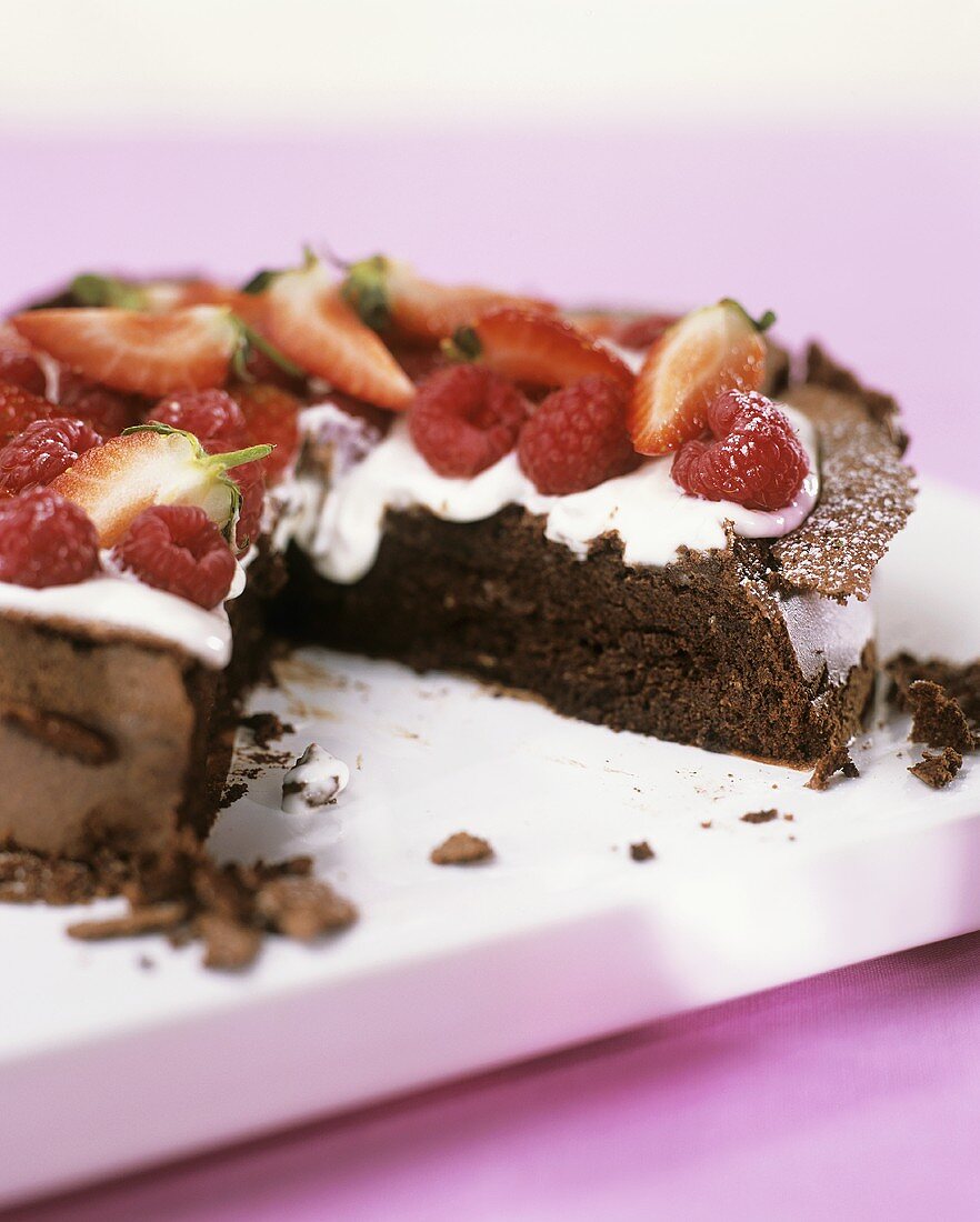 Chocolate cake with whipped cream and berries