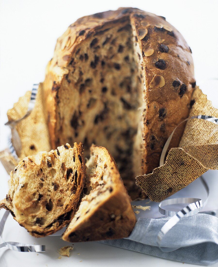 Almond and olive bread, partly sliced, on wrapping paper