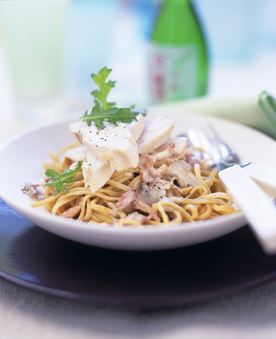 Spaghetti with ham and mushroom sauce and chicken breast