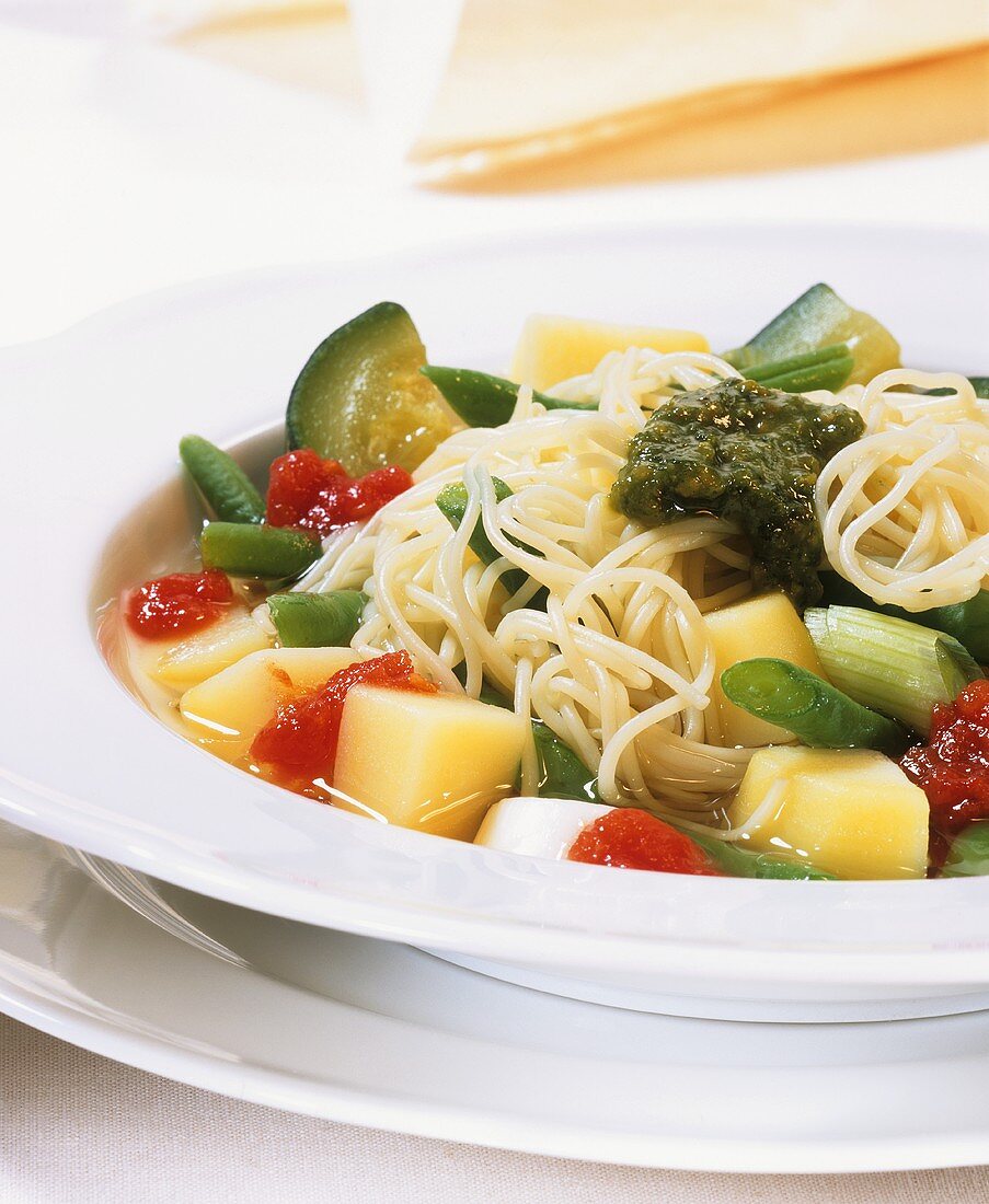 Vegetable stew with spaghetti and pesto
