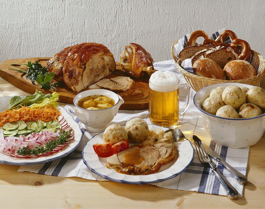 Soup, salad and roast pork with dumplings and beer