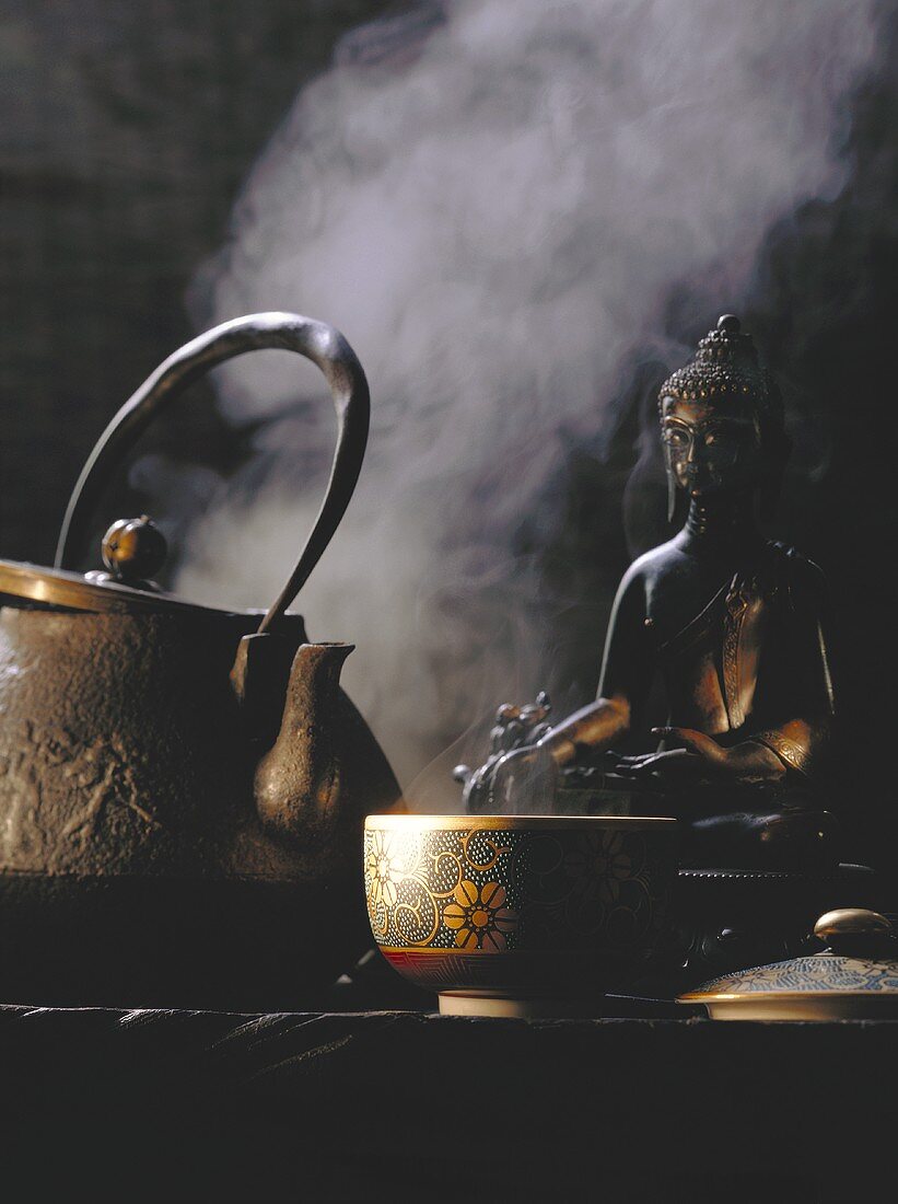 Decorated tea bowl; teapot; statue of Buddha