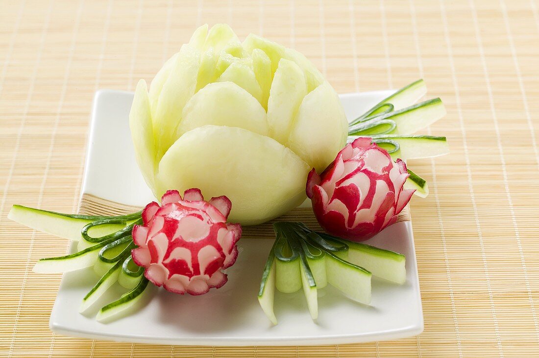 Large and small radish flowers with carved cucumber