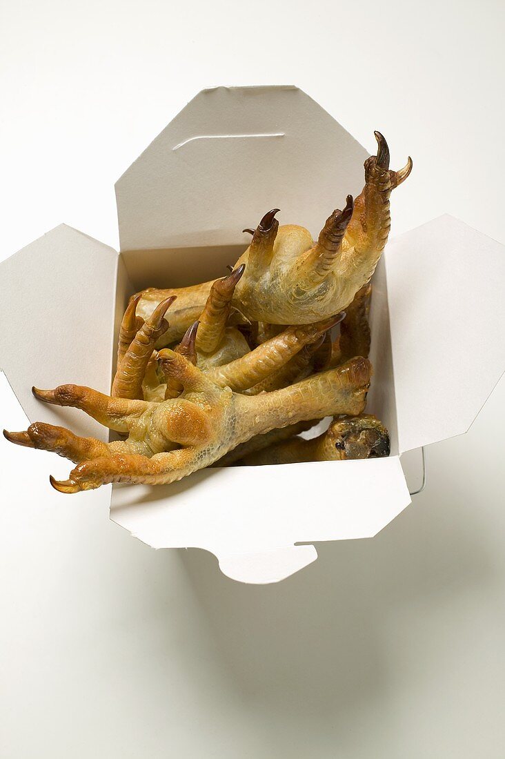 Deep-fried chicken feet to take away (Asian snack)