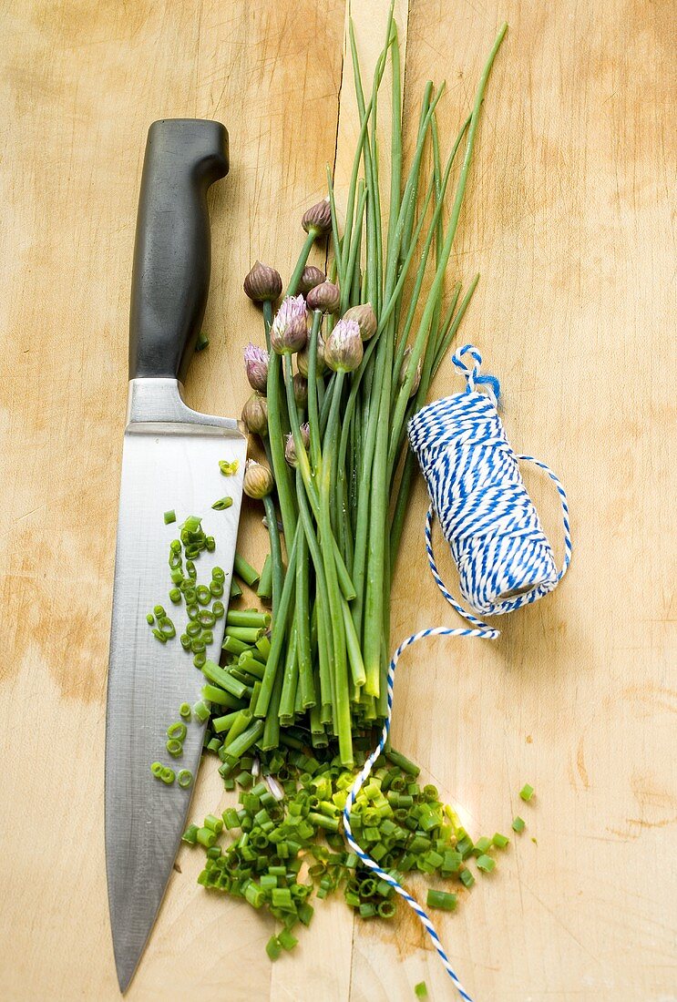 Fresh chives, partly chopped, with knife