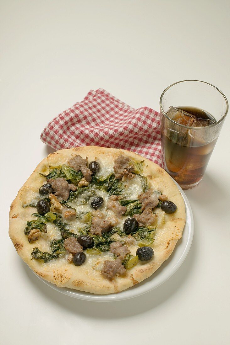 Pizza with tuna, chard and olives, glass of cola