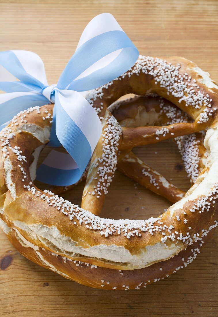 Two salted pretzels with blue and white bow (Bavaria)