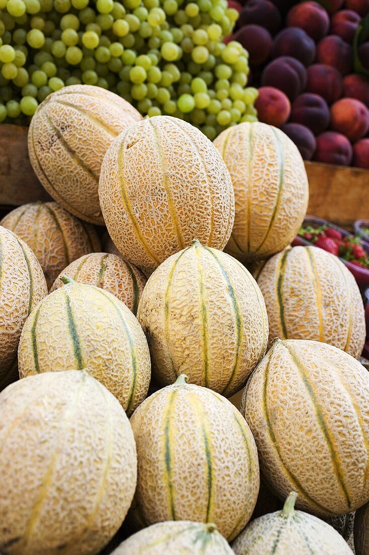 Fresh melons, grapes and peaches at a market