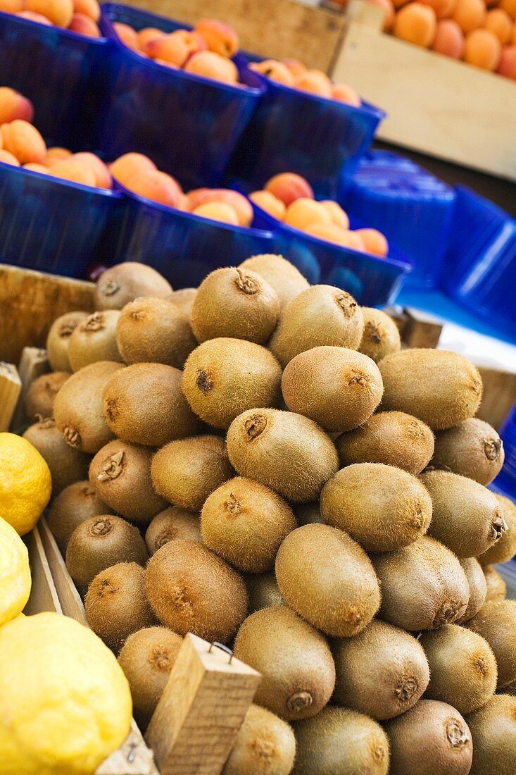 Kiwi fruits, lemons and apricots at a market