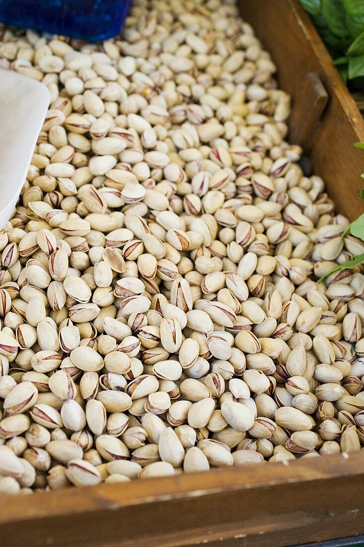 Pistachios in a wooden box at a market