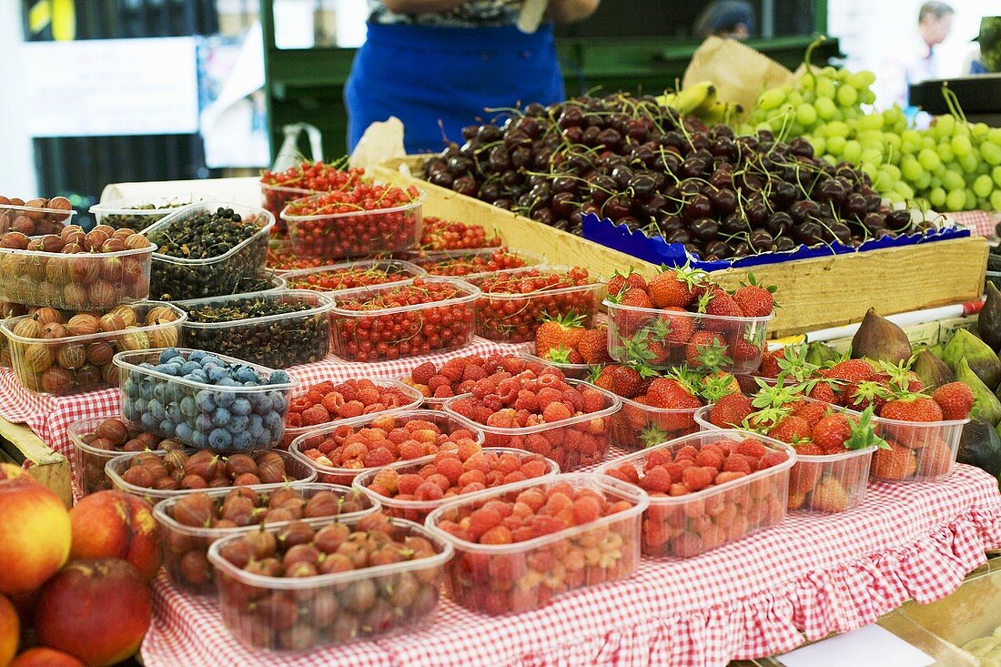 Fresh berries, cherries and grapes at a market