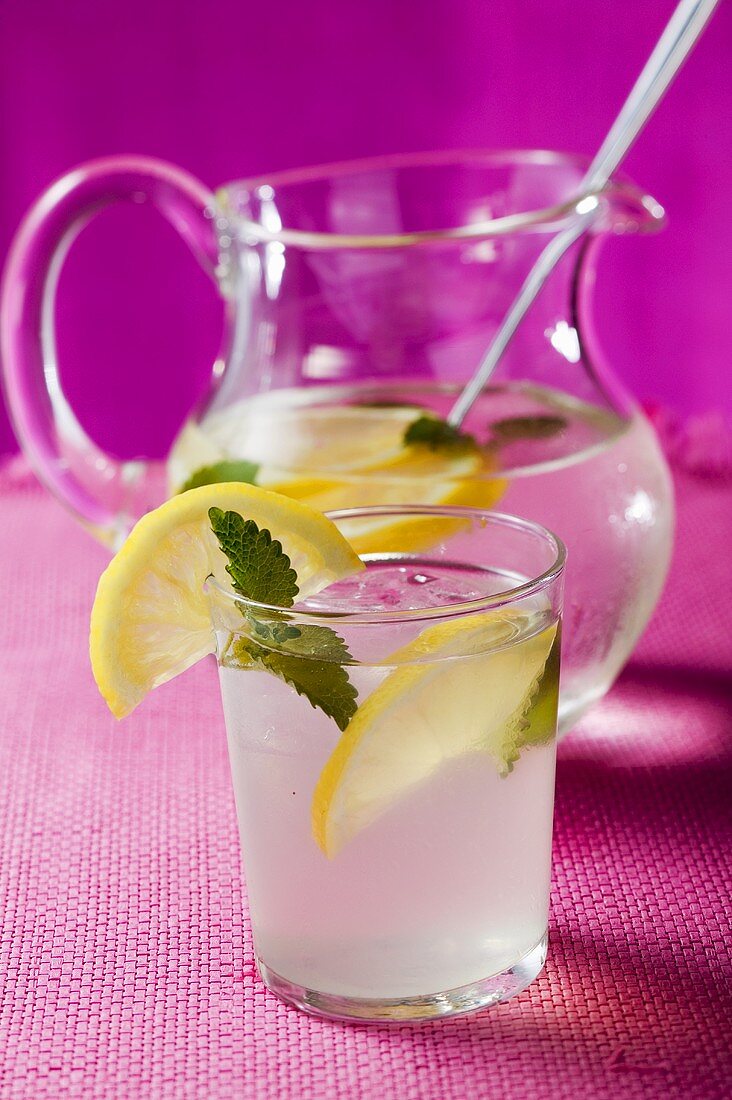 Lemonade with ice cubes and lemon balm