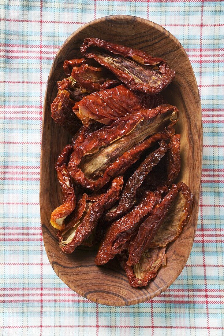 Dried tomatoes in wooden bowl