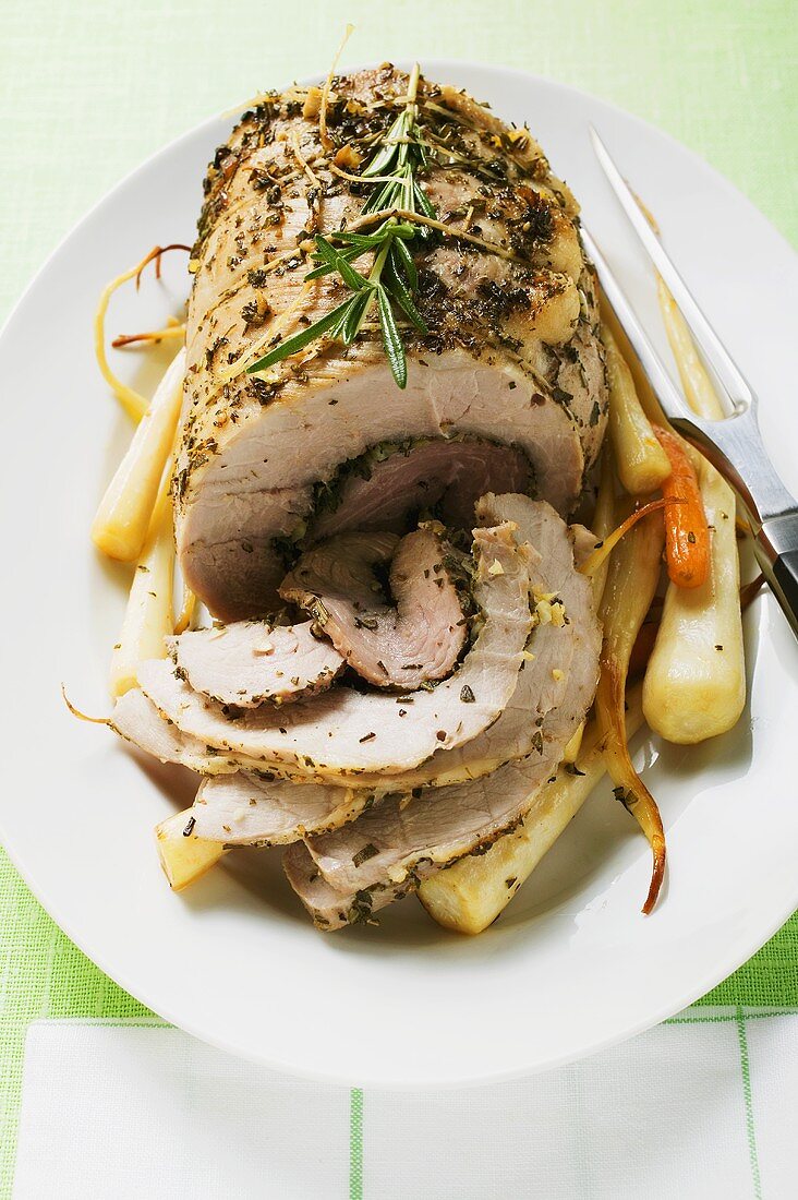 Roast turkey roll with root vegetables and herbs