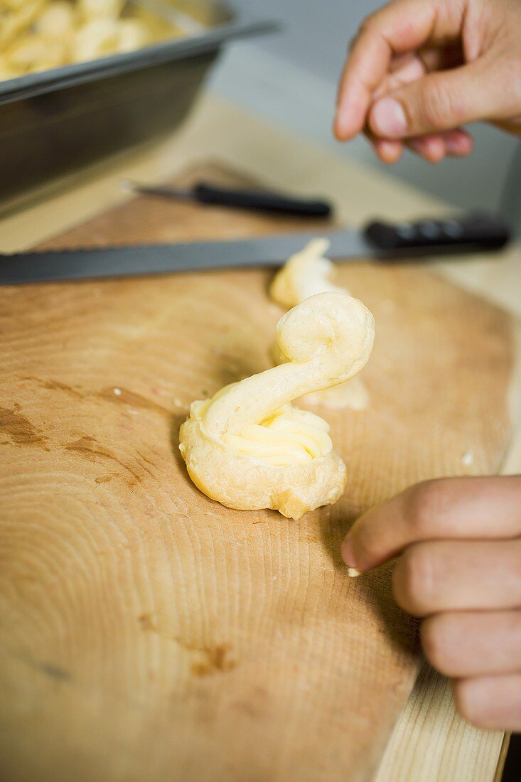 Making a choux pastry swan with cream