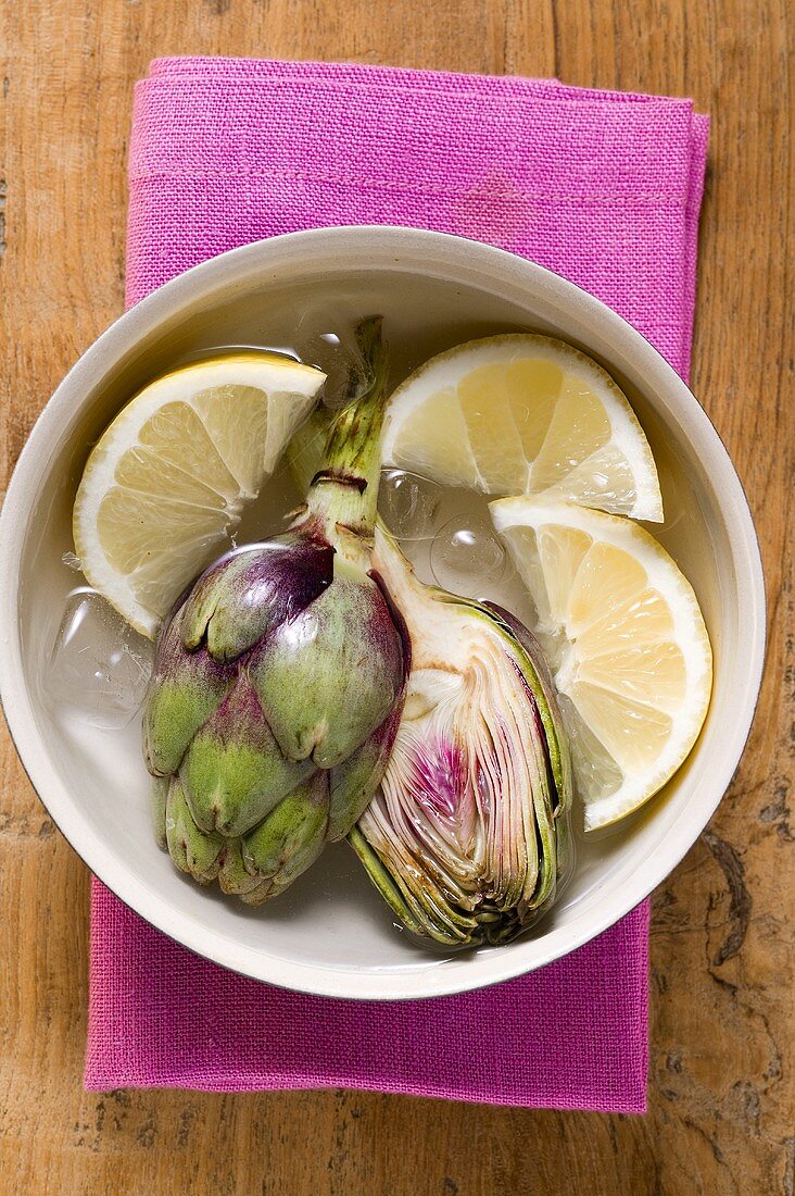 Fresh artichokes in lemon water