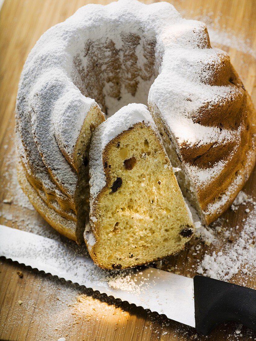 Gugelhupf with icing sugar, partly sliced