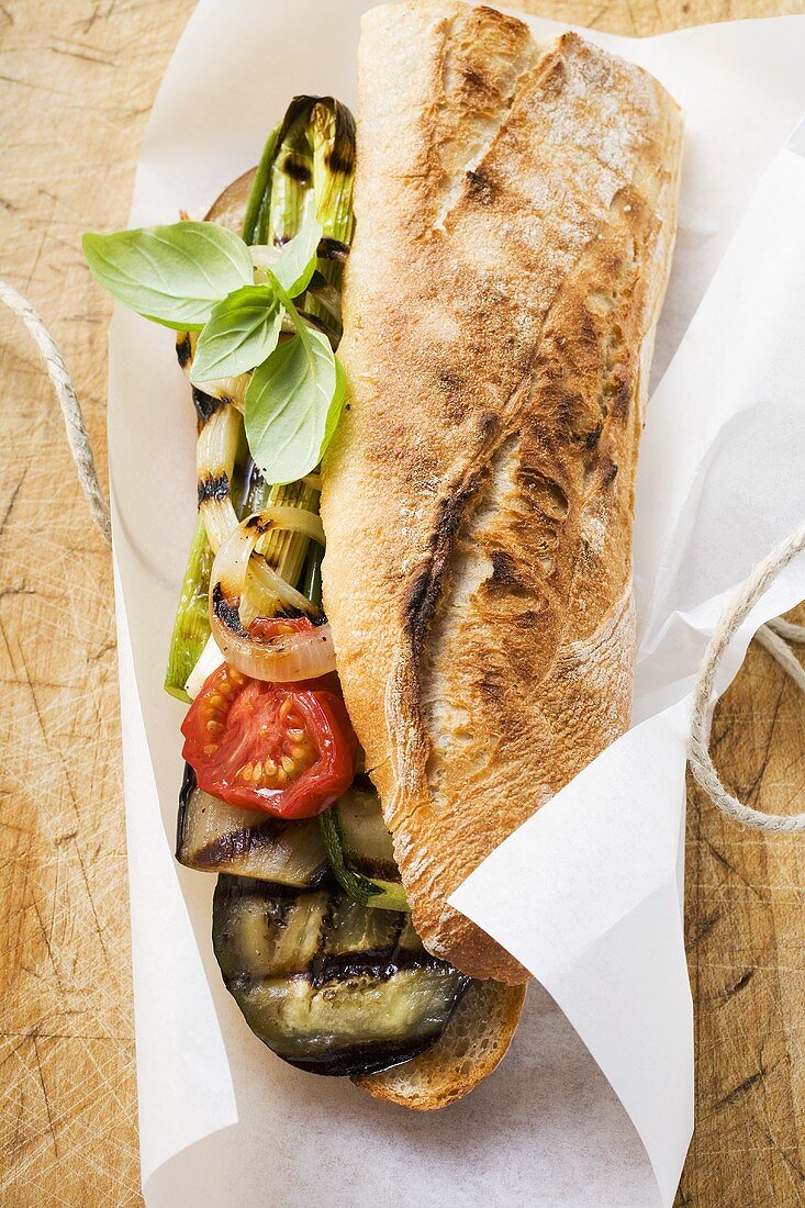 Grilled vegetables and basil in baguette