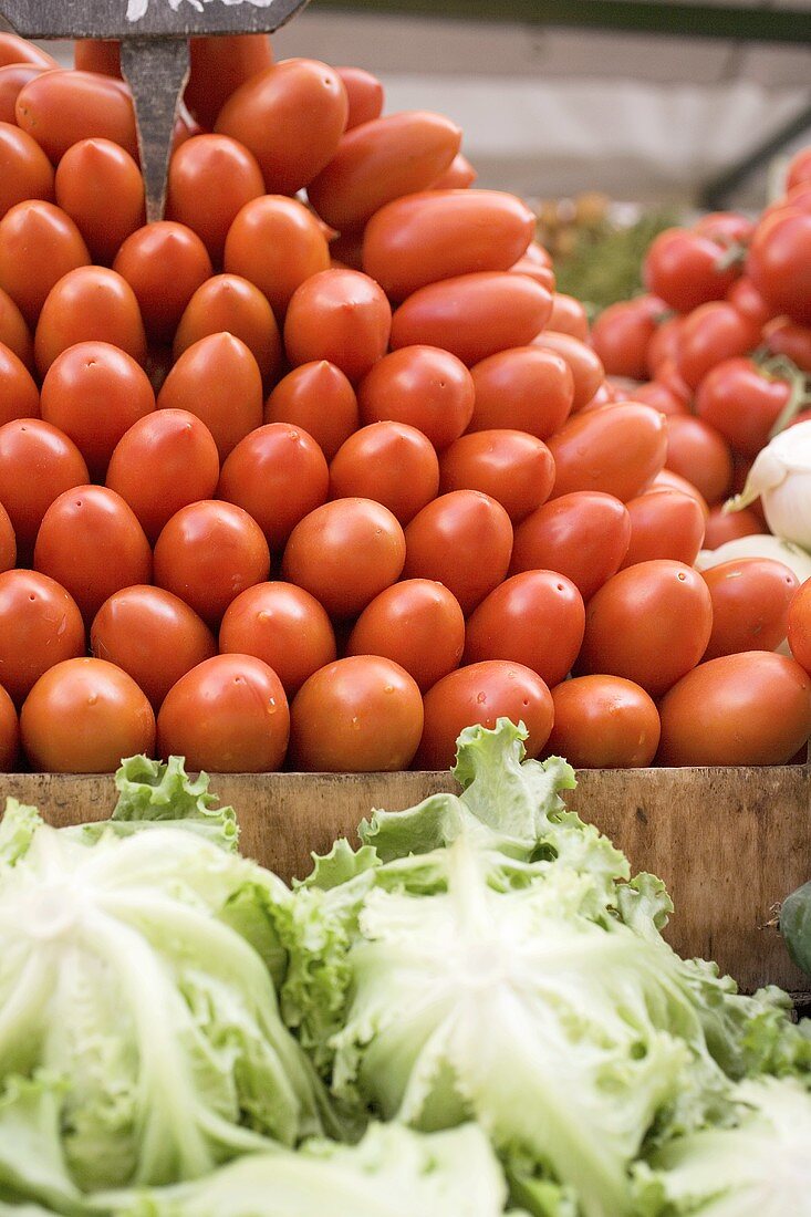 Plum tomatoes in a crate at a market