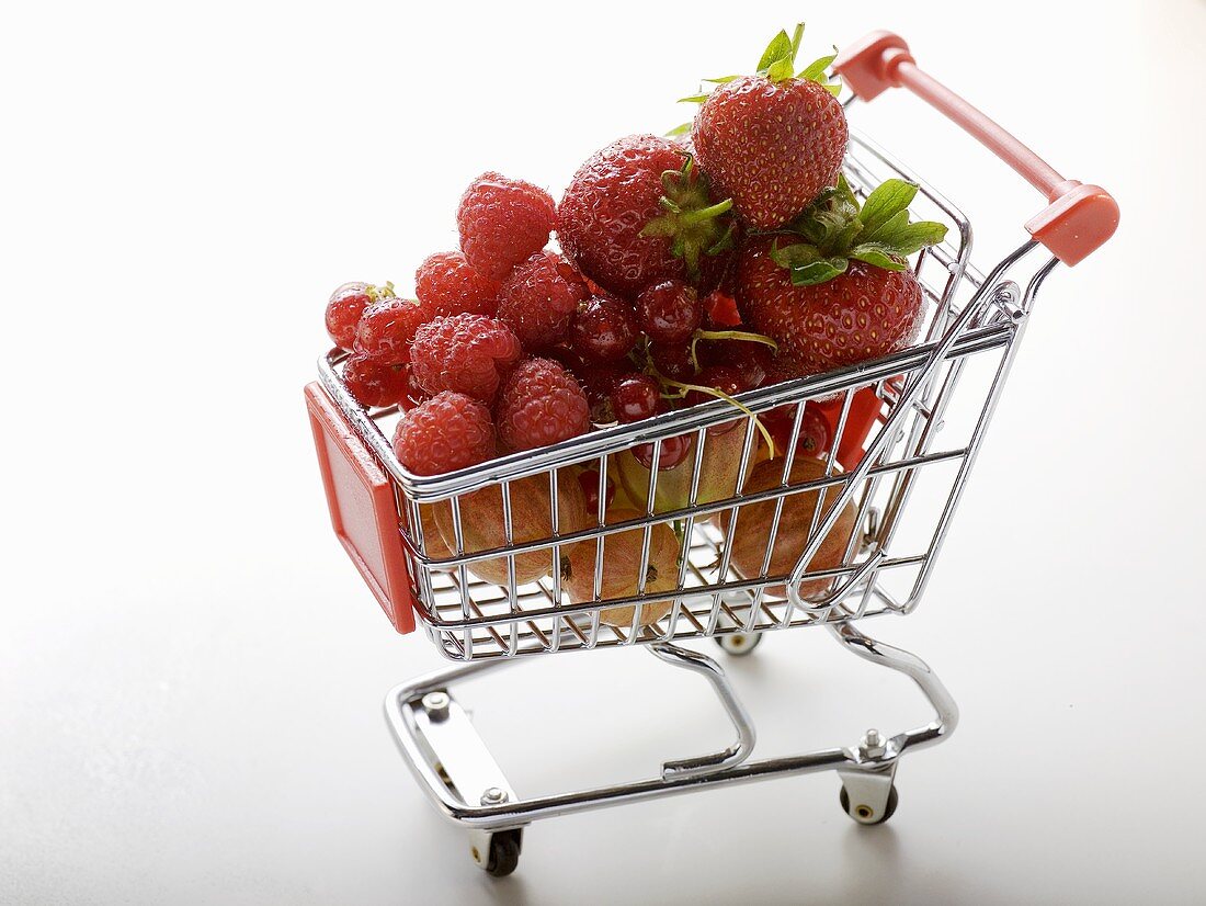 Assorted berries in toy shopping trolley
