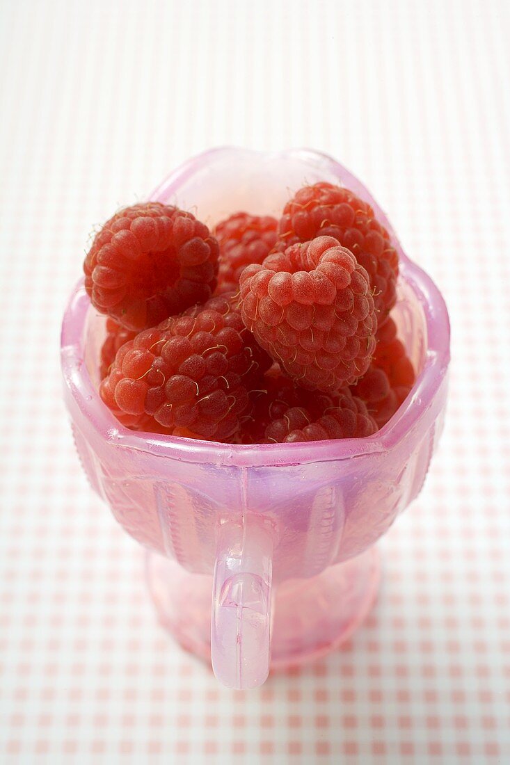 Fresh raspberries in pink jug