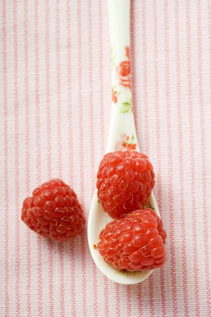 Raspberries on patterned spoon
